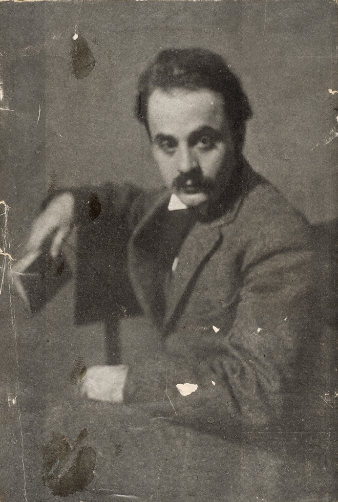 Old Picture of Kahlil Gibran sit and holding a book